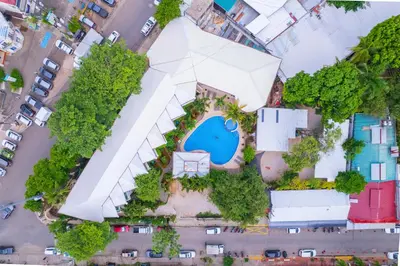 an overhead view of a white building with a pool at Hotel Mar Rey in Tamarindo