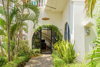 an entrance to a building with plants and a hallway at Hotel Mar Rey in Tamarindo