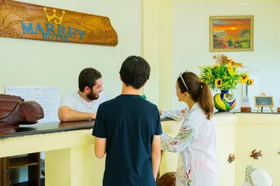 a man and a woman standing at a counter in a store at Hotel Mar Rey in Tamarindo