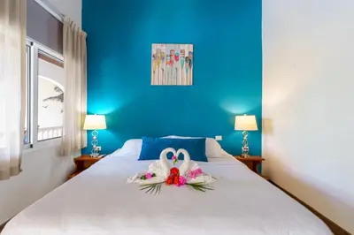 a bedroom with a bed with a swan decoration on it at Hotel Mar Rey in Tamarindo