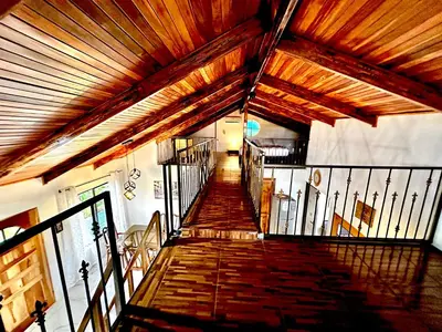 a staircase in a building with a wooden ceiling at Blu House Nature & Tours in Chachagua