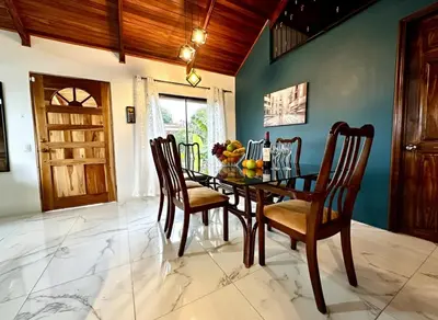 a dining room with a wooden table and chairs at Blu House Nature & Tours in Chachagua