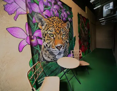 a mural of a leopard on a wall at Blu House Nature & Tours in Chachagua