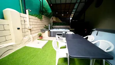 a patio with a table and chairs and a grill at Blu House Nature & Tours in Chachagua