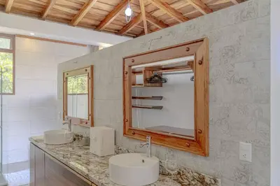 a bathroom with two sinks and a mirror at Cloud Forest House Monteverdes in Monteverde Costa Rica