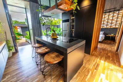 a kitchen with a large island with stools at Danta Santa Lofts in Fortuna