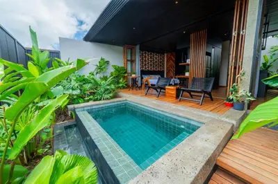 a swimming pool in the middle of a house with a patio at Danta Santa Lofts in Fortuna