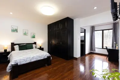 a bedroom with a large bed and a large window at Viva Guest House in San José