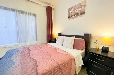 a bedroom with a large bed and a window at Viva Guest House in San José