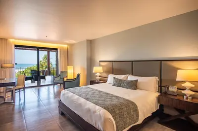 a hotel room with a bed and a balcony at Crocs Resort & Casino in Jacó