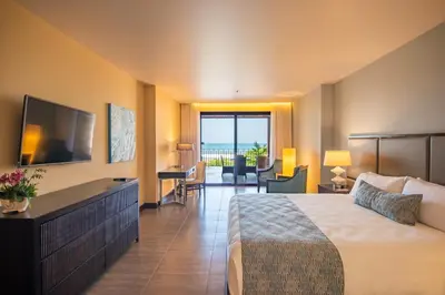 a hotel room with a bed and a television at Crocs Resort & Casino in Jacó