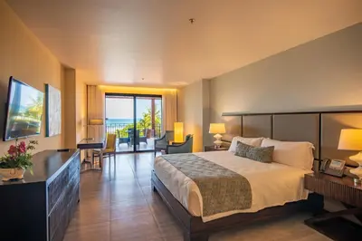 a hotel room with a bed and a view of the ocean at Crocs Resort & Casino in Jacó