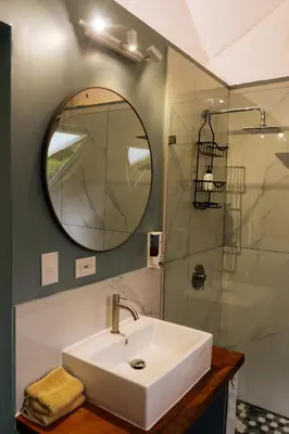 a bathroom with a sink and a mirror at Pura Vista Glamping in El Castillo de La Fortuna