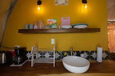 a bathroom with a tub and a yellow wall at Pura Vista Glamping in El Castillo de La Fortuna