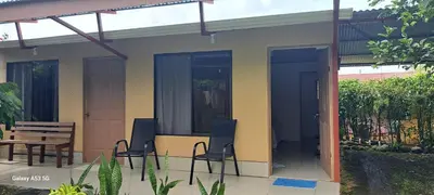 a patio with chairs and a table and a house at Paradise Rio Celeste 2 in Bijagua