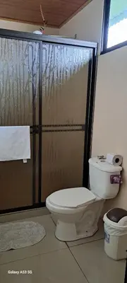 a bathroom with a toilet and a shower at Paradise Rio Celeste 2 in Bijagua