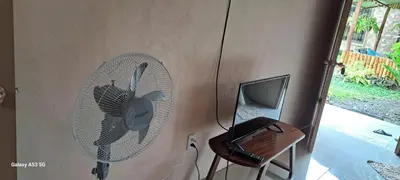 a room with a fan and a desk with a laptop at Paradise Rio Celeste 2 in Bijagua