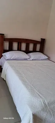 a bedroom with a large bed with white sheets and pillows at Paradise Rio Celeste 2 in Bijagua