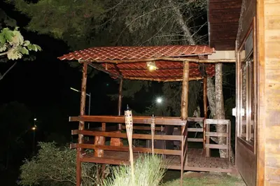 a gazebo on the side of a house at night at Cabaña El Ciprés: Vistas increíbles y Mirador in Turrialba