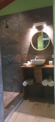 a bathroom with a sink and a mirror at Casita Maripier Colón in Morado