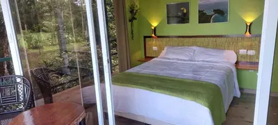 a small bedroom with a bed and a balcony at Casita Maripier Colón in Morado