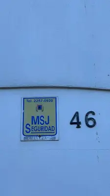 a sign on the side of a building at SJO Oasis Hostel in San José
