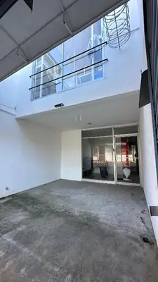 an empty parking lot with a balcony in a building at SJO Oasis Hostel in San José