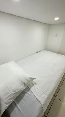 a large white bed in a white room at SJO Oasis Hostel in San José