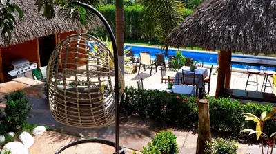 a bird cage sitting next to a pool at Hotel Vista Bonita in Parrita