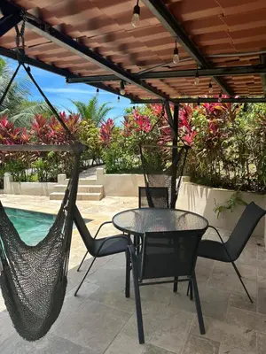 a patio with a table and chairs under a pergola at Tropical Oasis in Ojochal in Ojochal