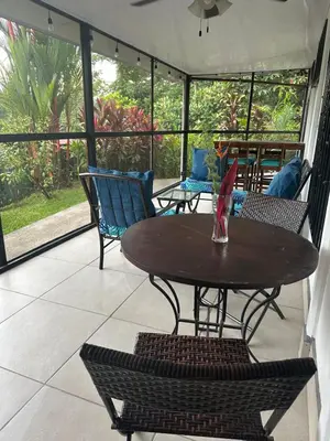 a patio with a wooden table and chairs at Tropical Oasis in Ojochal in Ojochal