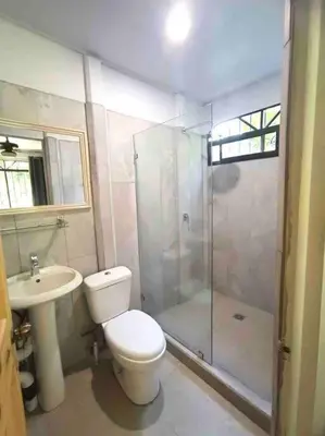 a bathroom with a toilet and a shower and a sink at Tropical Oasis in Ojochal in Ojochal
