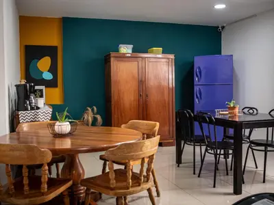 a dining room with a wooden table and chairs at Lolas Hostal Hab Individual 6 - 8 Baño compartido in San José