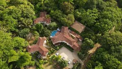 an overhead view of a house in the forest at The Hideaway Hotel in Sámara