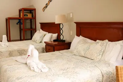 a white stuffed animal is sitting on a bed at The Hideaway Hotel in Sámara