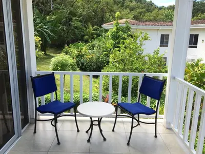 a porch with three chairs and a table and a view at The Hideaway Hotel in Sámara