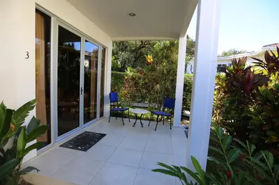 a patio with chairs and a table on a house at The Hideaway Hotel in Sámara