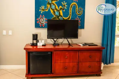 a television on top of a wooden dresser at The Hideaway Hotel in Sámara