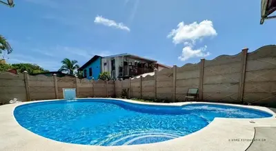 a large blue swimming pool in front of a fence at Legoon View in Tortuguero