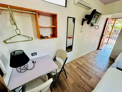 a small room with a white table and chairs at Legoon View in Tortuguero