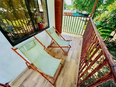 two chairs sitting on the porch of a house at Legoon View in Tortuguero