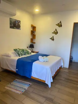 a bedroom with two beds and butterflies on the wall at Legoon View in Tortuguero