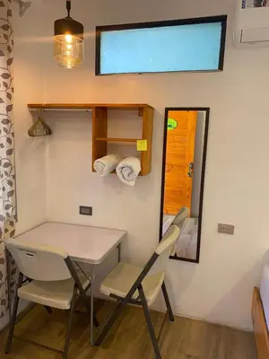 a room with a table and chairs and a window at Legoon View in Tortuguero