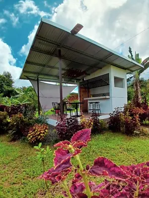 a building with a roof with a table in a garden at Flora Glamping de Abuela in Fortuna