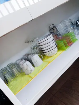 a shelf with plates and other dishes in a kitchen at Flora Glamping de Abuela in Fortuna