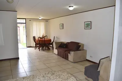 a living room with a couch and a table at SERENITY HOME H Y M in Turrialba