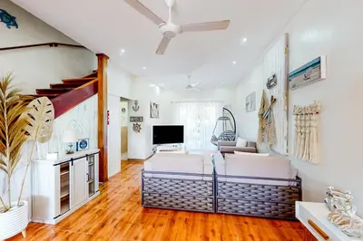 a living room with a couch and a tv at La Cometa 16 in Tamarindo