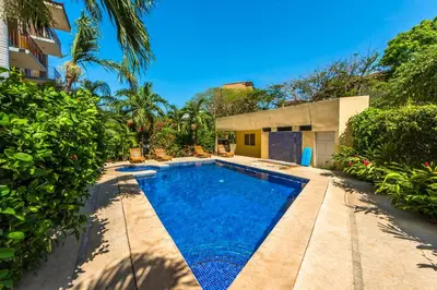 a swimming pool in the backyard of a house at La Cometa 16 in Tamarindo