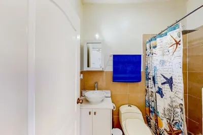 a small bathroom with a toilet and a sink at La Cometa 16 in Tamarindo