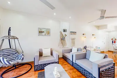 a living room with two chairs and a swing at La Cometa 16 in Tamarindo